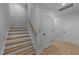 Elegant staircase with wood treads, white risers, and a light wood handrail, leading to an upper level at 811 Maple Berry Ln # 103, Raleigh, NC 27607