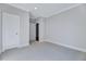 Comfortable bedroom with soft carpeting and access to a hallway and closet at 811 Maple Berry Ln # 104, Raleigh, NC 27607