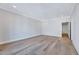 Bright bedroom with hardwood floors and recessed lighting, leading to hallway and bathroom at 811 Maple Berry Ln # 104, Raleigh, NC 27607
