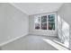 Bright bedroom features neutral carpet and a large window overlooking the yard at 811 Maple Berry Ln # 104, Raleigh, NC 27607