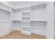 Walk-in closet featuring wood floors and custom shelving for storage at 811 Maple Berry Ln # 104, Raleigh, NC 27607
