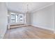 Bright dining room features hardwood floors, chandelier, and large windows at 811 Maple Berry Ln # 104, Raleigh, NC 27607