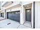 Exterior view showcasing the garage and front door of the modern townhome at 811 Maple Berry Ln # 104, Raleigh, NC 27607