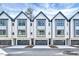 Beautiful exterior view of modern townhomes with sleek designs and a gray and white color palette at 811 Maple Berry Ln # 104, Raleigh, NC 27607