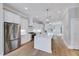 Beautiful kitchen features stainless steel appliances, large island, and hardwood floors at 811 Maple Berry Ln # 104, Raleigh, NC 27607