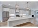 Bright kitchen with white cabinets, stainless steel appliances, and a large center island at 811 Maple Berry Ln # 104, Raleigh, NC 27607