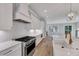 Modern kitchen boasts stainless steel appliances, white cabinets, and eat-in island at 811 Maple Berry Ln # 104, Raleigh, NC 27607