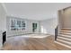 Open-concept living room features hardwood floors, fireplace, and large windows at 811 Maple Berry Ln # 104, Raleigh, NC 27607