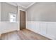 Small bedroom with a window, board and batten accent wall and wood-look floors at 811 Maple Berry Ln # 105, Raleigh, NC 27607