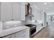 This modern kitchen features stainless steel appliances, white cabinets, and a tile backsplash, combining style with practicality at 811 Maple Berry Ln # 105, Raleigh, NC 27607