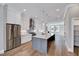 Modern kitchen features white cabinets, stainless steel appliances, and a gray kitchen island at 811 Maple Berry Ln # 105, Raleigh, NC 27607