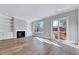Charming living room featuring built-in bookshelves, a fireplace, and a sliding glass door to the backyard, blending indoor/outdoor living at 811 Maple Berry Ln # 105, Raleigh, NC 27607