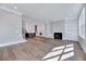This living room showcases a seamless transition from a modern kitchen with a fireplace, enhancing the open concept living at 811 Maple Berry Ln # 105, Raleigh, NC 27607