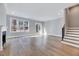 Spacious living room with hardwood floors, a fireplace, and large windows, creating a bright and inviting atmosphere at 811 Maple Berry Ln # 105, Raleigh, NC 27607