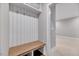 Bright mudroom features a built-in bench with coat hooks and storage shelves for organization at 811 Maple Berry Ln # 105, Raleigh, NC 27607