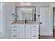 Bathroom offers vanity with drawers and a framed mirror over granite countertop at 811 Maple Berry Ln # 106, Raleigh, NC 27607