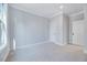 Bright bedroom features neutral carpet, base molding, and fresh paint at 811 Maple Berry Ln # 106, Raleigh, NC 27607