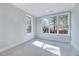 Bedroom with abundant natural light through large windows, neutral carpet at 811 Maple Berry Ln # 106, Raleigh, NC 27607