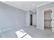 Neutral carpeted bedroom offers open closet space and a connected bathroom at 811 Maple Berry Ln # 106, Raleigh, NC 27607