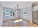 Dining area filled with natural light, featuring hardwood floors and stylish chandelier at 811 Maple Berry Ln # 106, Raleigh, NC 27607