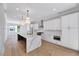 Bright kitchen features island with seating, stainless appliances, and custom cabinets at 811 Maple Berry Ln # 106, Raleigh, NC 27607