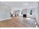 Open-concept living space showcases hardwood floors, fireplace, and an adjacent kitchen at 811 Maple Berry Ln # 106, Raleigh, NC 27607