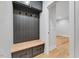 Convenient mudroom area with custom storage, bench seating, and hooks at 811 Maple Berry Ln # 106, Raleigh, NC 27607