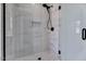 Contemporary glass enclosed shower features sleek marble look tile and a black showerhead at 811 Maple Berry Ln # 106, Raleigh, NC 27607