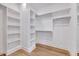 Bright walk-in closet with white shelving and wood flooring at 811 Maple Berry Ln # 106, Raleigh, NC 27607