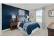 Comfortable bedroom with wooden furniture, baseball decor, and bright natural light streaming through the window at 8841 Tartan Clan Dr, Willow Springs, NC 27592