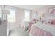 Charming pink bedroom with two beds and ample natural light at 8841 Tartan Clan Dr, Willow Springs, NC 27592