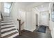 Bright foyer with hardwood floors, a staircase, and a view of the front door at 8841 Tartan Clan Dr, Willow Springs, NC 27592
