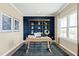 Well-lit home office with custom shelving and a large window, perfect for remote work at 8841 Tartan Clan Dr, Willow Springs, NC 27592