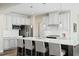 Spacious kitchen with a large island, seating for four, and stainless steel appliances at 8841 Tartan Clan Dr, Willow Springs, NC 27592