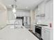 Bright kitchen featuring stainless steel appliances, a spacious island, and modern pendant lighting at 8841 Tartan Clan Dr, Willow Springs, NC 27592