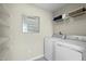 Functional laundry area equipped with a washing machine, dryer, and ample shelving for storage at 8841 Tartan Clan Dr, Willow Springs, NC 27592
