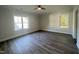 Bedroom featuring hardwood floors, two large windows, and neutral paint at 2710 - A Mansfield Ave, Durham, NC 27703