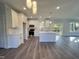 Spacious open kitchen with white cabinets, a central island, stainless appliances, and views to the living area at 2710 - A Mansfield Ave, Durham, NC 27703