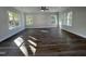 Large empty living room featuring hardwood floors, a ceiling fan, and lots of windows for natural light at 2710 - A Mansfield Ave, Durham, NC 27703