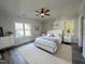 Bright bedroom with windows, ceiling fan, neutral walls, and an ensuite bathroom at 2710 - A Mansfield Ave, Durham, NC 27703