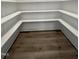 Walk-in pantry with white shelves and wood flooring providing ample storage space at 2710 - A Mansfield Ave, Durham, NC 27703