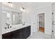 Bathroom featuring double vanity, a large mirror, tile flooring and large walk-in closet at 55 Firefly Ln, Louisburg, NC 27549