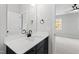 Modern bathroom with white countertop, black fixtures, and ample natural light from a nearby window at 55 Firefly Ln, Louisburg, NC 27549