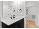 Modern bathroom featuring sleek vanity, black fixtures, white countertop, and access to the stairs at 55 Firefly Ln, Louisburg, NC 27549