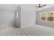 Spacious bedroom with neutral walls, carpet, ceiling fan, and natural light at 55 Firefly Ln, Louisburg, NC 27549