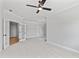 Large bedroom with carpet, ceiling fan, and French doors to another room at 55 Firefly Ln, Louisburg, NC 27549