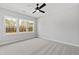 Bedroom with large windows that provide natural light and carpet flooring at 55 Firefly Ln, Louisburg, NC 27549