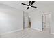 Spacious carpeted bedroom featuring a ceiling fan and white trim with ensuite bathroom at 55 Firefly Ln, Louisburg, NC 27549