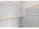Walk-in closet with multiple clothing rods and shelf at 55 Firefly Ln, Louisburg, NC 27549