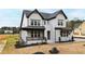 New construction home with white brick, black trim, covered porch and tasteful landscaping at 55 Firefly Ln, Louisburg, NC 27549